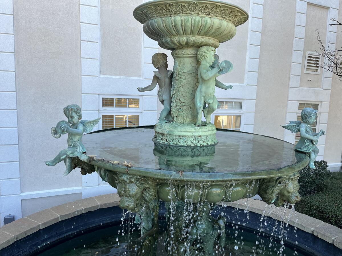 Bronze cherub fountain at commercial building